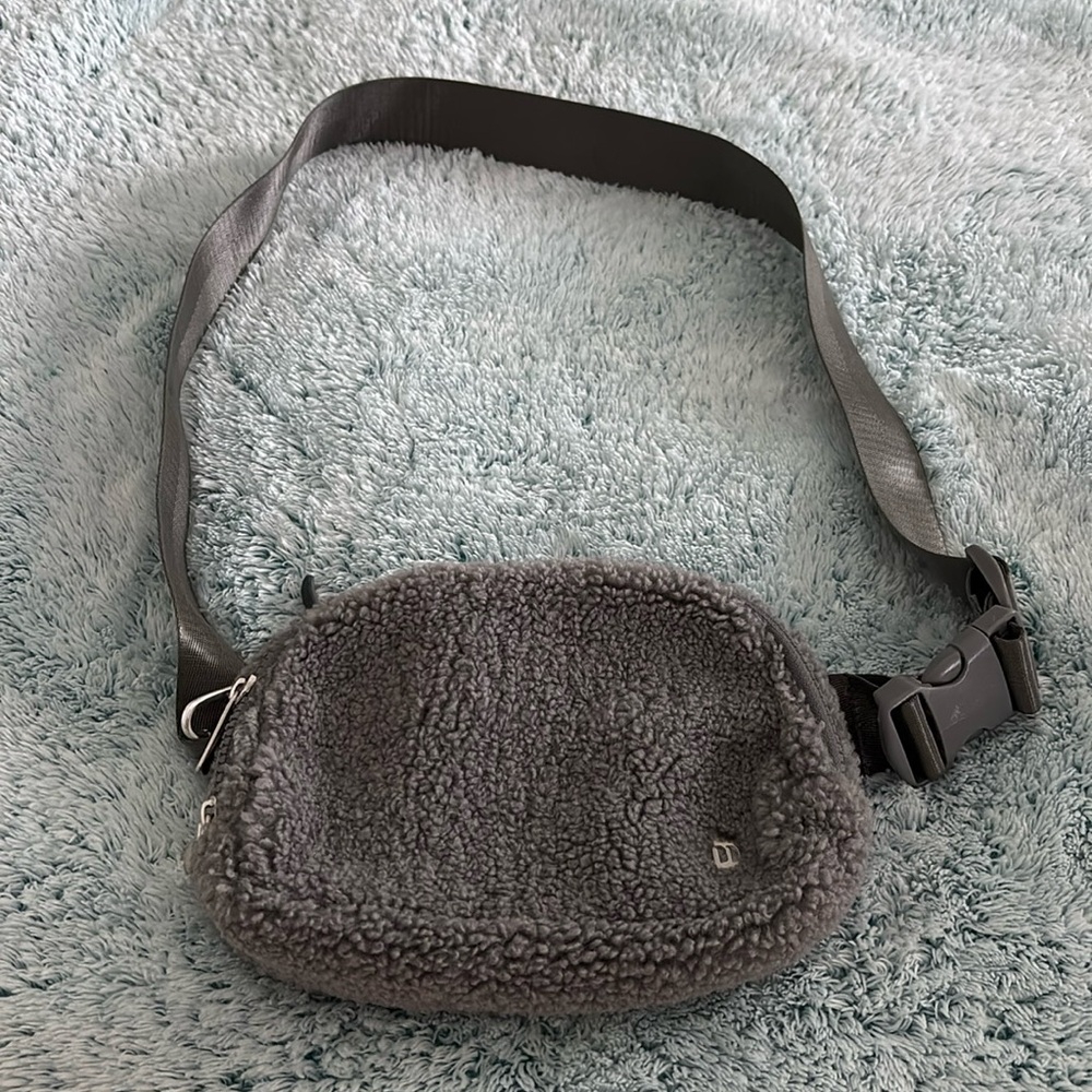 Gray fleece crossbody belt bag with adjustable strap